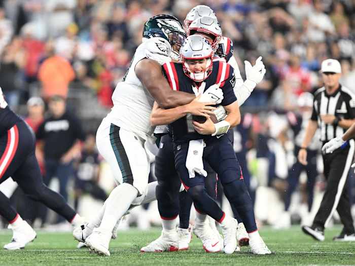 New England Patriots quarterback Mac Jones (10) is tackled by Philadelphia Eagles defensive tackle Jalen Carter (98) during the second half at Gillette Stadium.